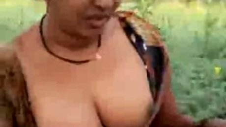 Mature dirty-minded Hindu brunette flashes boobs and cunt outdoors